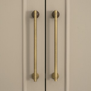 May include: A set of three ceramic mugs with a speckled, matte finish. Each mug features a different color: light blue, cream, and gray. The mugs have a simple, modern design with a rounded shape and a comfortable handle.