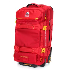 May include: A red rolling travel bag with yellow accents. The bag has multiple compartments, straps, and buckles. The bag has the words "Granite Gear" and "Cross-Trek" printed on it. The bag has a handle on top and wheels on the bottom.