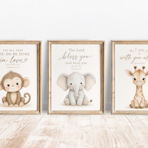 May include: Three framed wall art prints featuring watercolor illustrations of a baby monkey, a baby elephant, and a baby giraffe. Each print includes religious text: Let all that you do be done in love, The Lord bless you, and I am with you always.