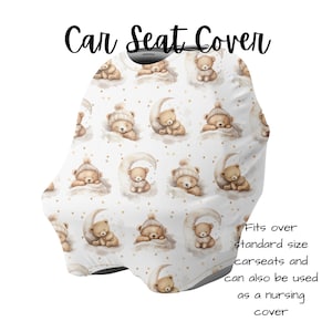 May include: White car seat cover featuring a repeating pattern of watercolour teddy bears wearing hats and sleeping on crescent moons. The text "Car Seat Cover" is at the top. It fits standard car seats and can be used as a nursing cover.