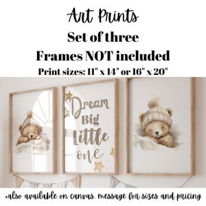 May include: A set of three art prints with illustrations of teddy bears in hats. The prints are framed in wood, with the words "Dream Big Little One." Print sizes are 28 x 36 cm or 41 x 51 cm.