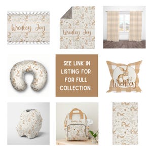 May include: A nursery decor collection featuring a beige and brown bunny rabbit pattern. The collection includes a crib sheet, blanket, nursing pillow, diaper bag, car seat cover, and throw pillow. The items are personalized with the name "Wrenley Joy".