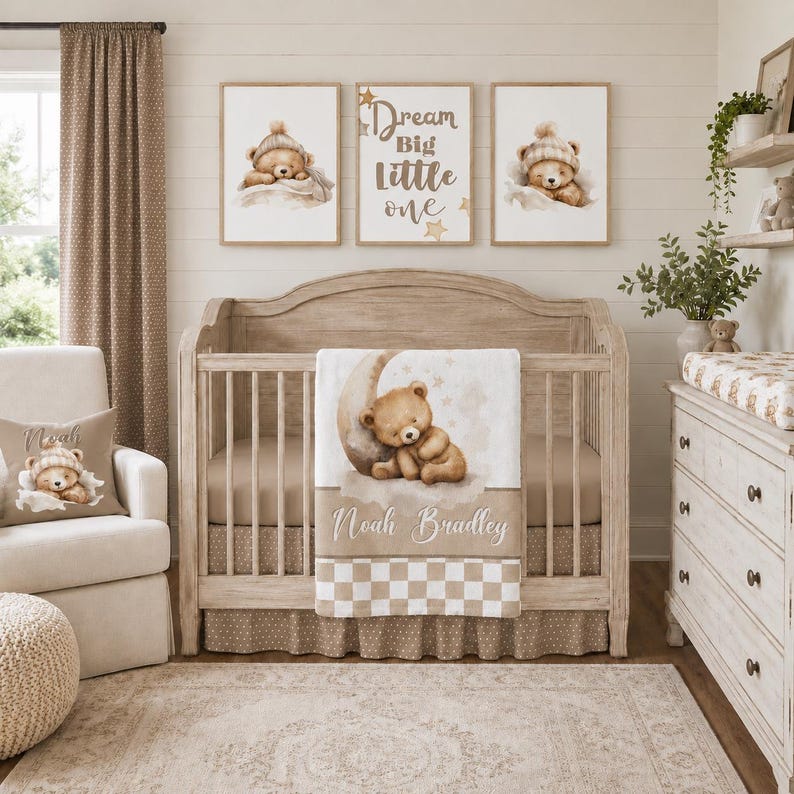 May include: A nursery interior with a crib, rocking chair, and dresser in neutral colours. The crib has a teddy bear-themed blanket and bedding. Three framed prints above the crib show a teddy bear. A pillow on the chair also has a teddy bear design.