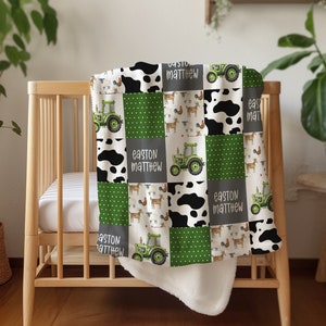 May include: A green, white, and black patchwork baby blanket with a tractor, cow, and rooster design. The blanket has the name "Easton Matthew" repeated on it.