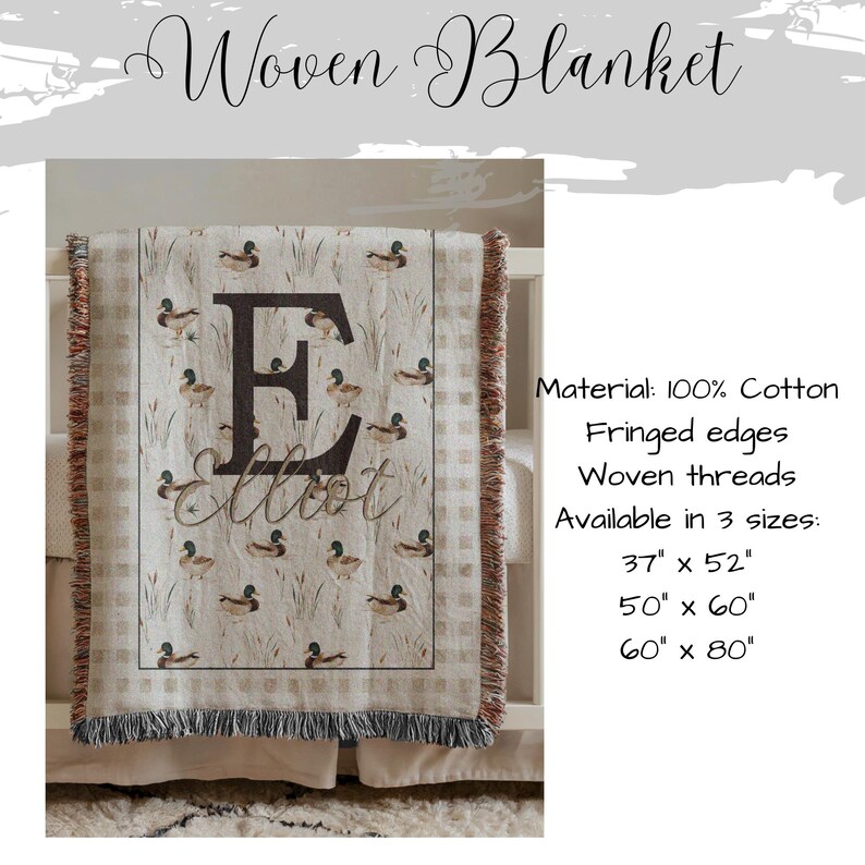 May include: A woven blanket featuring a repeating mallard duck and reed pattern with a large letter E and the name Elliot printed in the center. The blanket has fringed edges and is made of 100% cotton. Available in 37 by 52, 50 by 60, and 60 by 80 inches.