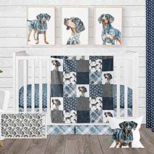 May include: A blue and white baby crib bedding set with a patchwork quilt featuring a blue and white dog print. The set includes a crib skirt, a fitted sheet, a pillow, and a blanket.