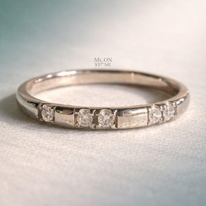 May include: A set of three ceramic mugs with a speckled, matte finish. The mugs are in cream, light grey, and dark grey. Each mug has a simple, minimalist design and a rounded handle. Ideal for tea or coffee.