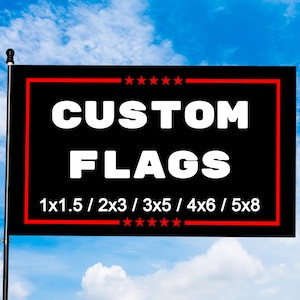 May include: A black flag with a red border and white text that reads "CUSTOM FLAGS." Below the text are size options: 1x1.5, 2x3, 3x5, 4x6, and 5x8. The flag is against a blue sky.