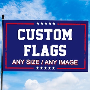 May include: A rectangular blue flag featuring a red border and white text that reads CUSTOM FLAGS ANY SIZE / ANY IMAGE. The design includes five white stars centred above the text and five white stars centred below the text on a pole.