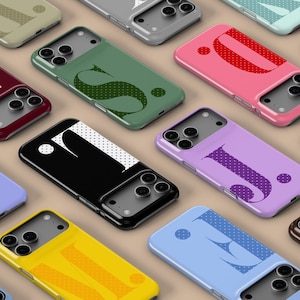 May include: A selection of mobile phone cases in various colours, each displaying a different letter. The cases are in shades such as pink, green, yellow, and blue. Each letter is designed with a dotted pattern. The cases are arranged on a neutral background.