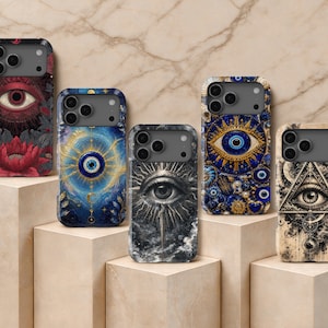 May include: Five smartphone cases featuring intricate designs of eyes, sunbursts, and celestial motifs. The cases display varied color palettes including deep red, vibrant blue, monochrome black and white, and cream, each with a camera cutout.