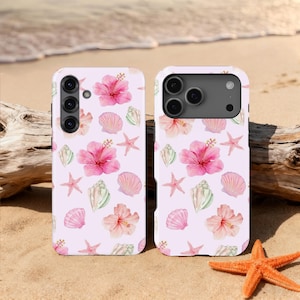 May include: Two phone cases featuring a light pink design with watercolour illustrations of pink hibiscus flowers, seashells, and starfish. The cases are on a sandy beach with a starfish.