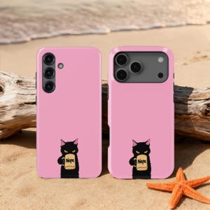 May include: A white ceramic mug with a black handle and the text "But First, Coffee" in a bold, black font. The mug is set against a blurred background, suggesting a cozy setting. The mug appears to be approximately 4 inches tall.