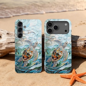 May include: Two phone cases with a sea turtle design. The cases feature a turtle with a brown and orange shell swimming in blue and green water. The background has a wavy pattern in shades of blue and white. The cases are on a sandy beach with a starfish.