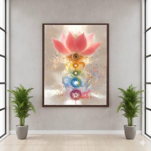 May include: A framed artwork featuring a pink lotus flower at the top, with a series of colorful chakra symbols descending below. The artwork has a watercolor style with a neutral background and is displayed in a room with plants.