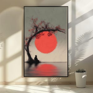 May include: Framed art print featuring a serene scene. A silhouetted figure sits beneath a tree with red leaves, facing a large red sun reflected in the water. The artwork has a minimalist style with a calming aesthetic.