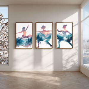 May include: Three framed art prints featuring watercolor silhouettes of yoga poses integrated with mountain and forest landscapes. The color palette includes teal, purple, and orange hues, set against a white background. The frames are a warm, natural wood tone.
