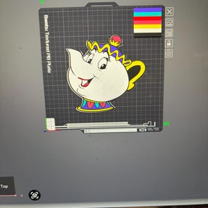 May include: A cartoon image of a white teapot with a yellow handle and spout, and a blue, yellow, and red decorative collar. The teapot has a smiling face and is set against a gray background with the text "Bambu Textured PE Plate".