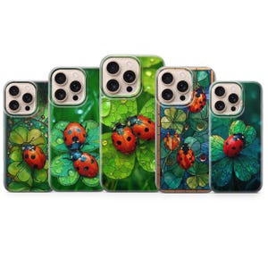 May include: Five phone cases with a ladybug and clover design. The cases feature a variety of backgrounds, including green leaves and a stained glass effect. The ladybugs are red with black spots.