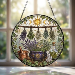 May include: A circular stained glass suncatcher featuring a sun and moon motif at the top, with bundles of dried herbs hanging from a wooden branch. Below, a purple bowl holds fresh flowers, alongside a copper mortar and pestle and a glass bottle.