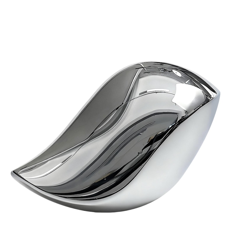 May include: A polished, silver-colored decorative bowl with a flowing, organic shape. The bowl has a smooth, reflective surface that creates a mirror-like effect, reflecting the surrounding environment. The design is modern and minimalist, suitable for home decor.