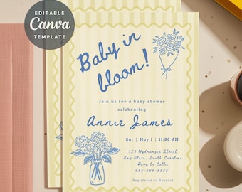 May include: A rectangular baby shower invitation card with a pale yellow vertical striped background and a scalloped border. The text reads Baby in bloom! Join us for a baby shower celebrating Annie James, Sat May 1, 11:00 AM.