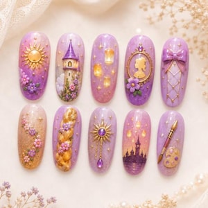 May include: A set of ten press-on nails featuring a purple and gold color palette with 3D embellishments. Designs include a sun, a tower, floating lanterns, a silhouette in a frame, a bow, a long braid, a paintbrush, and a paint palette.