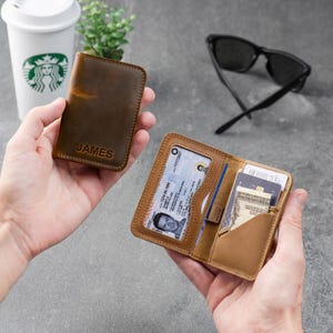 Two leather wallets in cognac and espresso displayed together on a gray surface