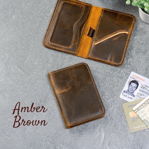 Slim zip-around leather wallet shown folded at a 360° angle on gray background