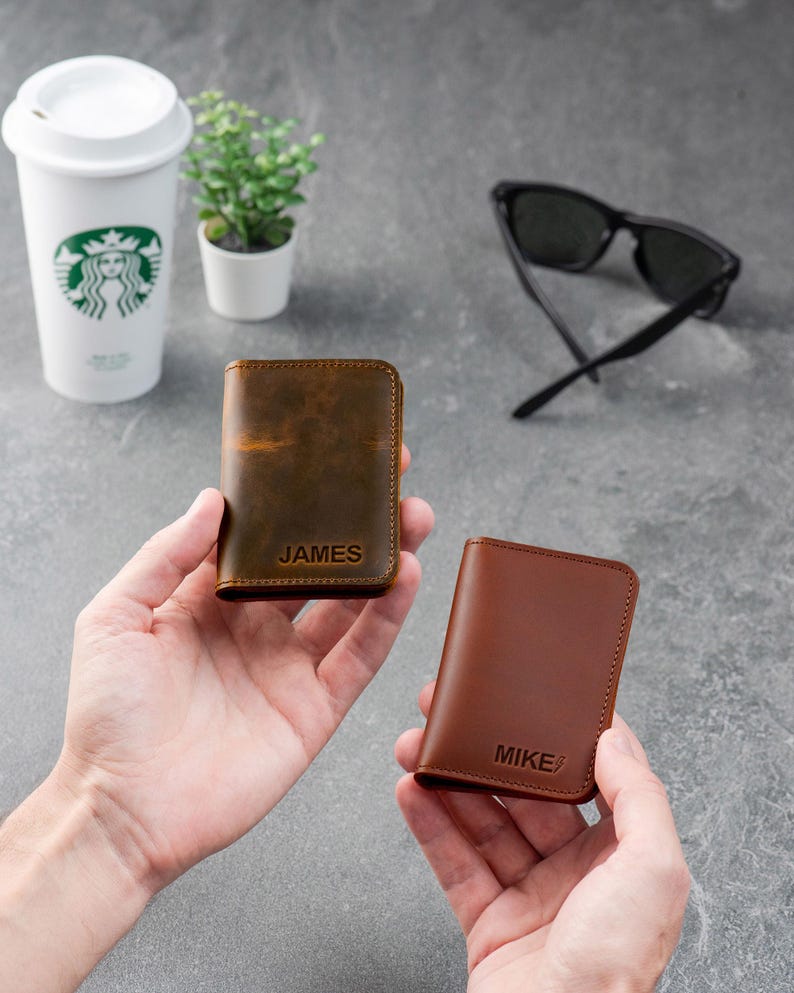 Person holding espresso leather wallet and showing size in hand