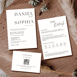 Puede incluir: Tres tarjetas de invitación de boda blancas con texto negro sobre una superficie marrón texturizada. La tarjeta de invitación principal dice "Daniel y Sophia" y la fecha "12.05.2027". Otras tarjetas incluyen detalles e información de RSVP.