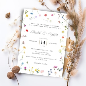 Puede incluir: Una invitación de boda con detalles florales. La invitación dice "Daniel & Sophia" con la fecha 14 de diciembre de 2028 y la hora 19:00. El texto está rodeado de flores de acuarela en varios colores.