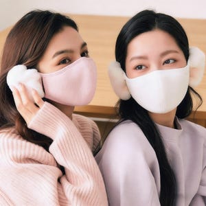 May include: Two people wearing face masks and fluffy ear muffs. One mask is light pink, the other is white. The ear muffs are white and fluffy. The people are wearing sweaters in shades of pink and lavender.