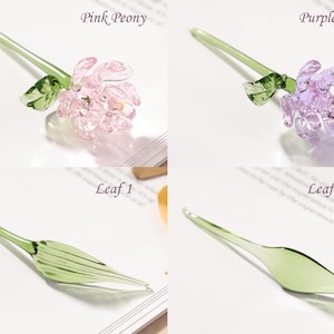 May include: Glass flower pens in pink and purple peony designs, and green leaf designs. The pens have a delicate, handcrafted appearance. The text "Pink Peony", "Purple Peony", "Leaf 1", and "Leaf 2" are visible.