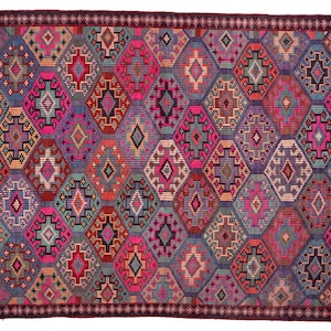 May include: A rectangular woven rug featuring a repeating diamond pattern in vibrant shades of magenta, purple, teal, orange, and black. The design includes intricate geometric motifs within each diamond shape, framed by a dark maroon border.