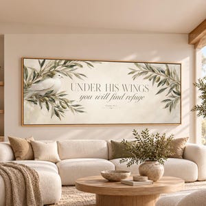 May include: A rectangular wall art piece featuring a white dove perched on olive branches on the left side. The center displays the text "UNDER HIS WINGS you will find refuge" followed by "Psalm 91:4". The background is a soft cream color.