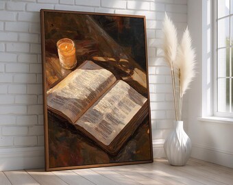 May include: An open book with text, a lit candle in a glass, and a framed painting. The painting depicts the book and candle on a wooden surface. A white vase with pampas grass sits near a window.