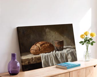 May include: A still life painting featuring a loaf of bread, a ceramic cup, and a draped cloth. The painting is displayed on a wooden cabinet, with a purple vase, a book, and a vase of yellow roses. The artwork has a warm, earthy color palette.