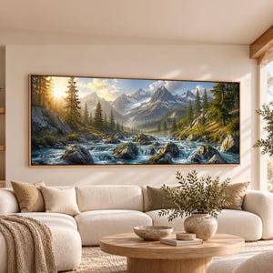May include: A rectangular landscape wall art print featuring a mountain range with snow-capped peaks, a flowing river with rocky rapids, and a dense forest of evergreen trees illuminated by a bright golden sunrise in the upper left corner.