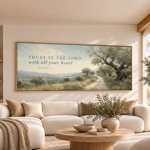 May include: A rectangular landscape wall art print in a thin wooden frame featuring a dirt path winding through an olive grove with rolling hills in the distance. The text "TRUST IN THE LORD with all your heart PROVERBS 3:5" is printed in black.