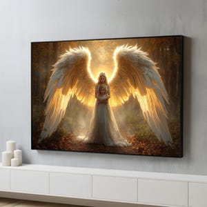 May include: A framed artwork depicts an angel with large, glowing white and gold wings, embracing a child. The artwork is set in a forest with warm, golden light, creating a serene and ethereal scene. The frame is black.