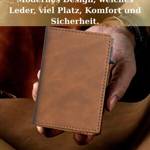 A person's hand holding a brown leather wallet or card holder, with a text overlay discussing modern design and materials.