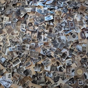May include: A collection of vintage black and white photographs, scattered across a surface. The images depict portraits, group photos, and landscapes, showcasing a variety of subjects and scenes from the past. The photographs vary in size and shape.