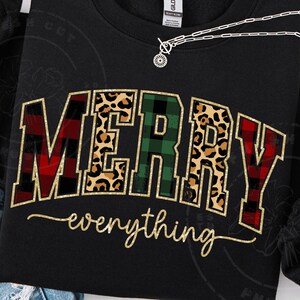 May include: Black sweatshirt with the words "MERRY everything" in a festive design. The word "MERRY" features plaid, leopard print, and green plaid patterns. The word "everything" is in a gold script font.