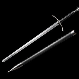 May include: A silver sword with a black leather-wrapped handle and a crossguard. The sword is displayed with its black scabbard against a black background. The blade is polished and reflects light.