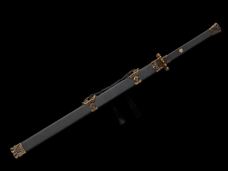 May include: A black sword with a decorative gold hilt and accents. The sword is in a black scabbard with gold embellishments. The blade is not visible. The sword is displayed against a black background.