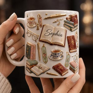 May include: A white ceramic mug featuring a colorful printed design of stacked vintage books, open books, teacups, pens, bookmarks, and eyeglasses. The center of the mug displays an open book with the name Sophia written in black cursive script.
