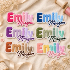 May include: Six embroidered name patches featuring the name Emily in a bold, rounded font with the name Morgan in a cursive script underneath. Each patch displays a unique color combination, including pink, blue, purple, green, brown, and pastel tones.