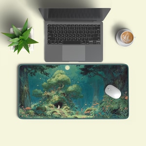 May include: A rectangular mouse mat with a fantasy forest scene, a full moon, and a small figure near a tree. A laptop, a white mouse, a cup of coffee, and a small potted plant are also visible.