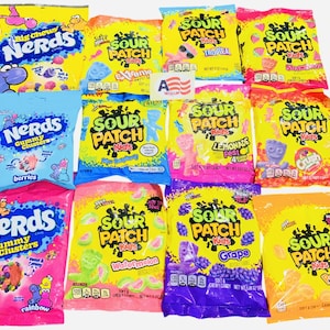 May include: A selection of brightly coloured candy bags, including Nerds and Sour Patch Kids. The bags display various flavours such as berries, watermelon, and grape. The packaging is vibrant, with bold text and images of the sweets.